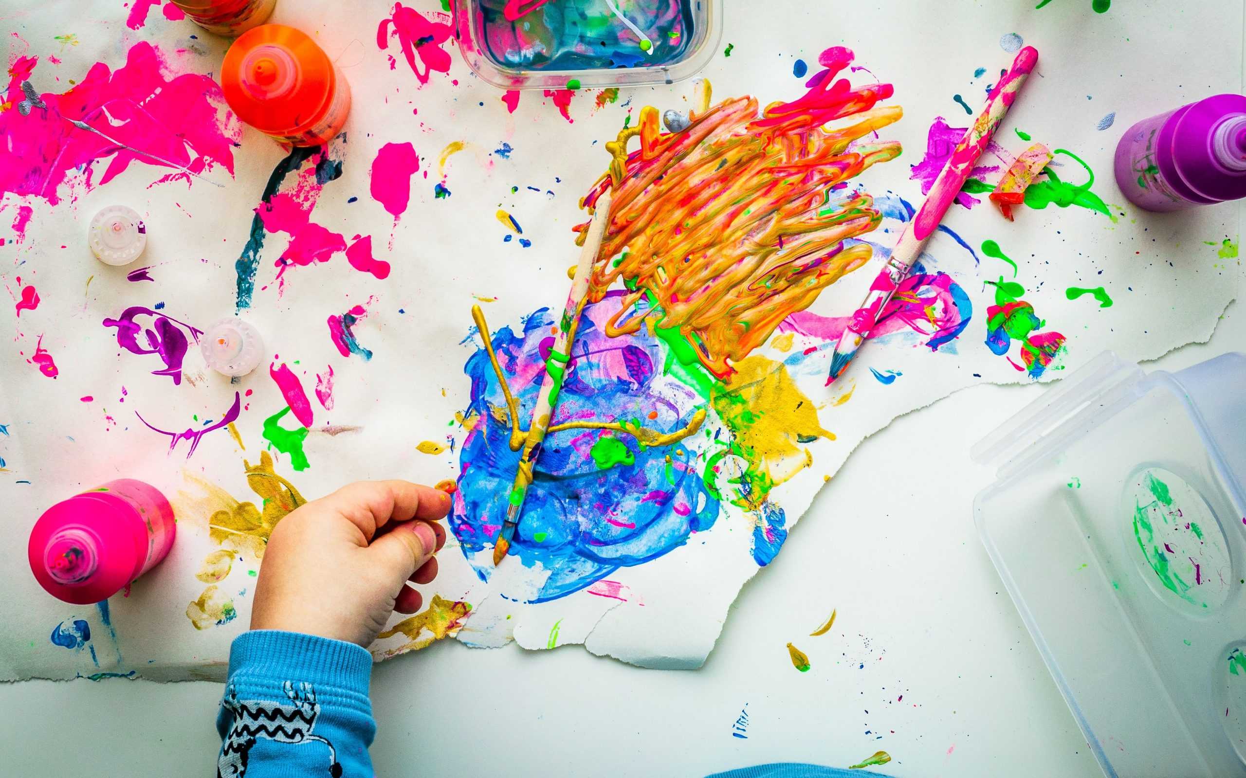 colorful paints on white working surface